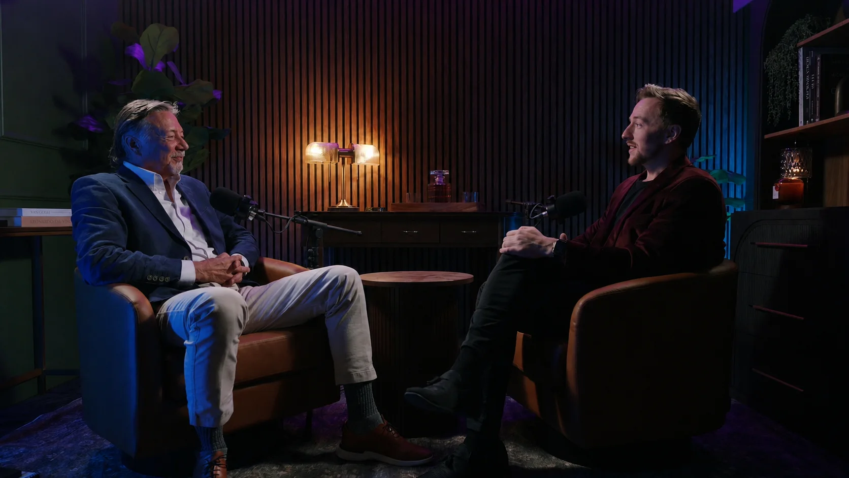 Two guests fully framed in the Pod Bros studio without water bottles in the shot