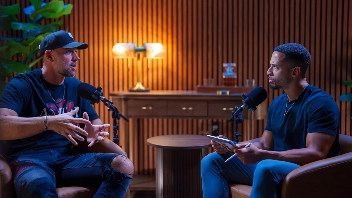 Two people in conversation with microphones in the Pod Bros Scottsdale studio.
